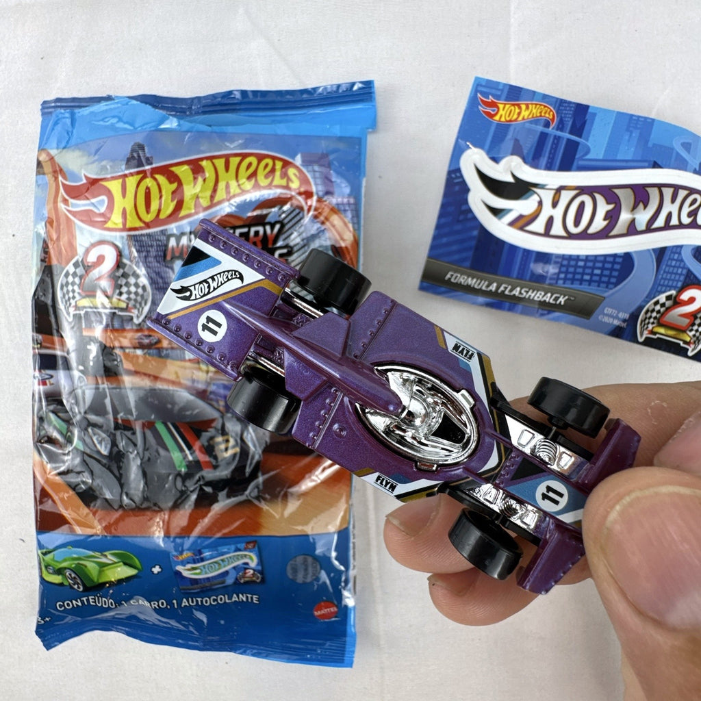 Hot Wheels Formula Flashback 1:64 scale purple diecast racer with gold wheels and matching sticker.