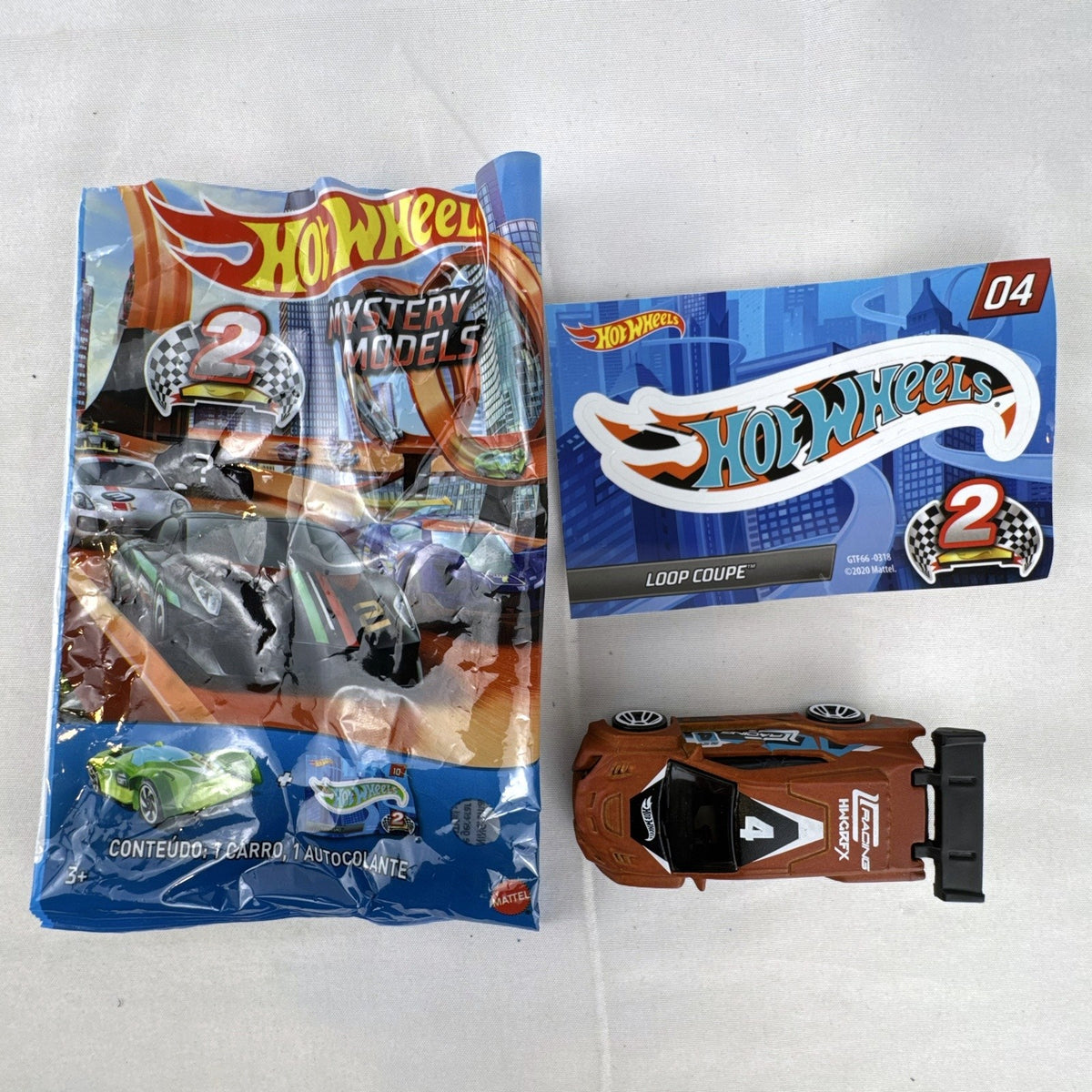 Hot Wheels 1:64 scale Loop Coupe diecast car in satin brown with HW Racing graphics and original foil packaging.