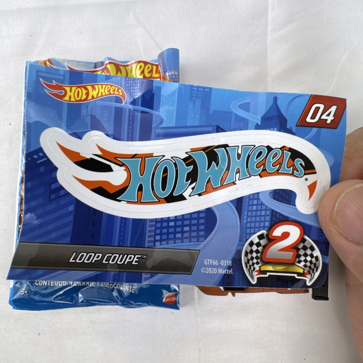 Hot Wheels 1:64 scale Loop Coupe diecast car in satin brown with HW Racing graphics and original foil packaging.