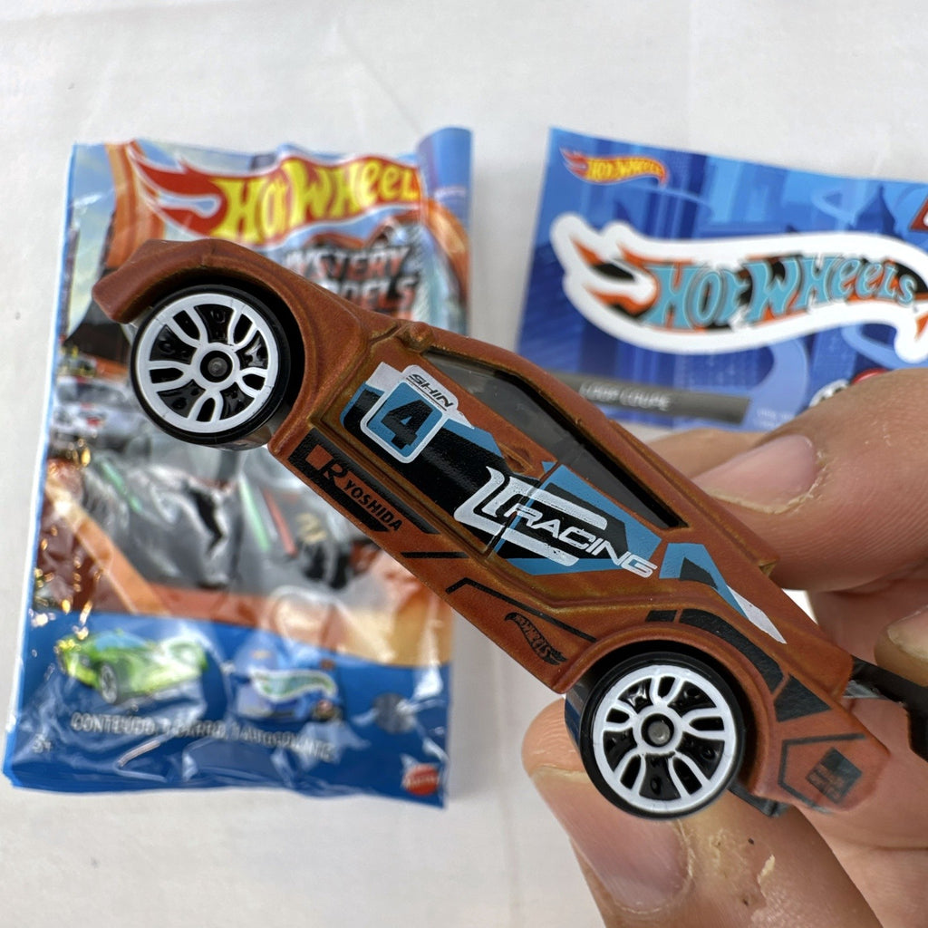 Hot Wheels 1:64 scale Loop Coupe diecast car in satin brown with HW Racing graphics and original foil packaging.
