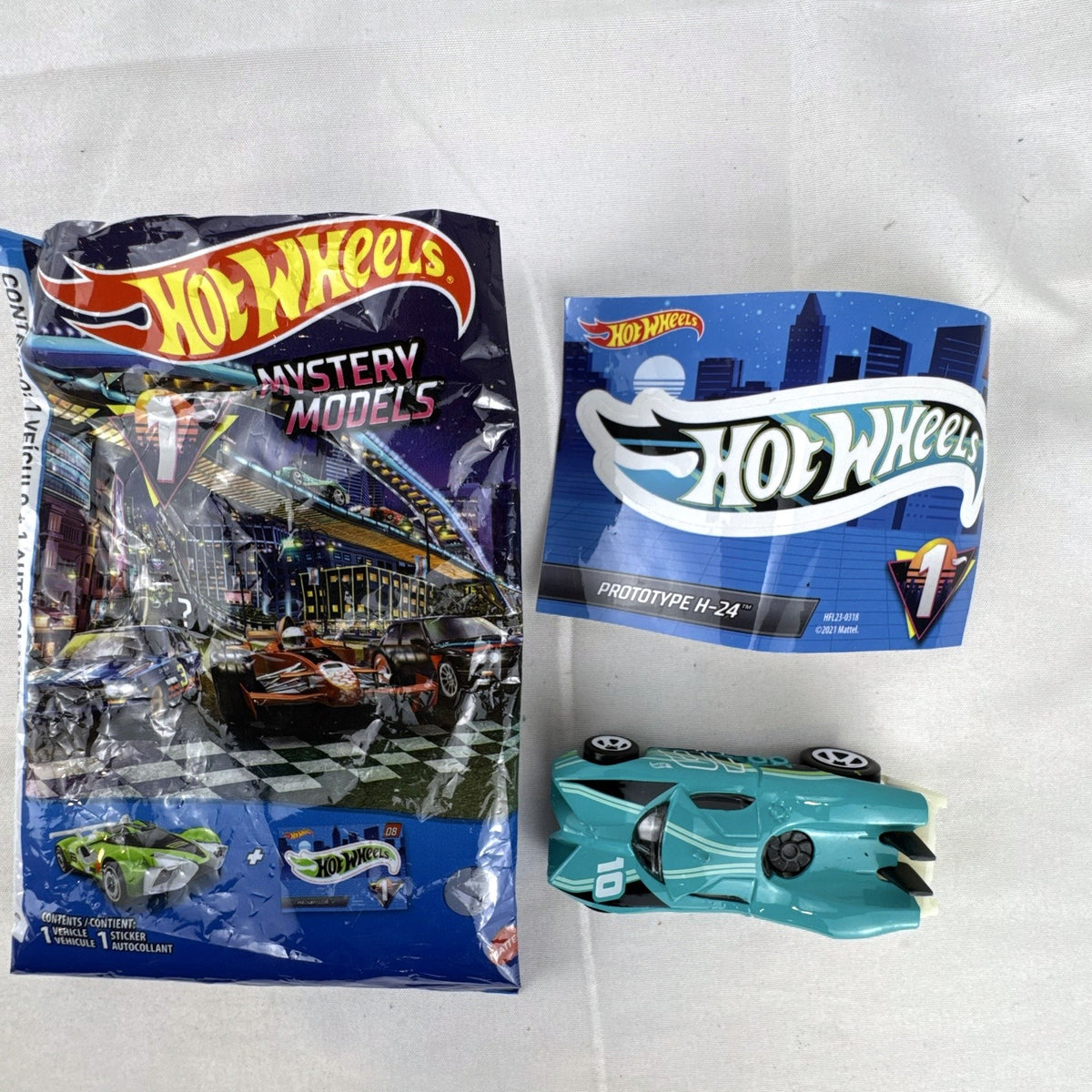 Teal Hot Wheels Prototype H-24 diecast 1:64 scale car with number 10 racing graphics and white 5-spoke wheels.