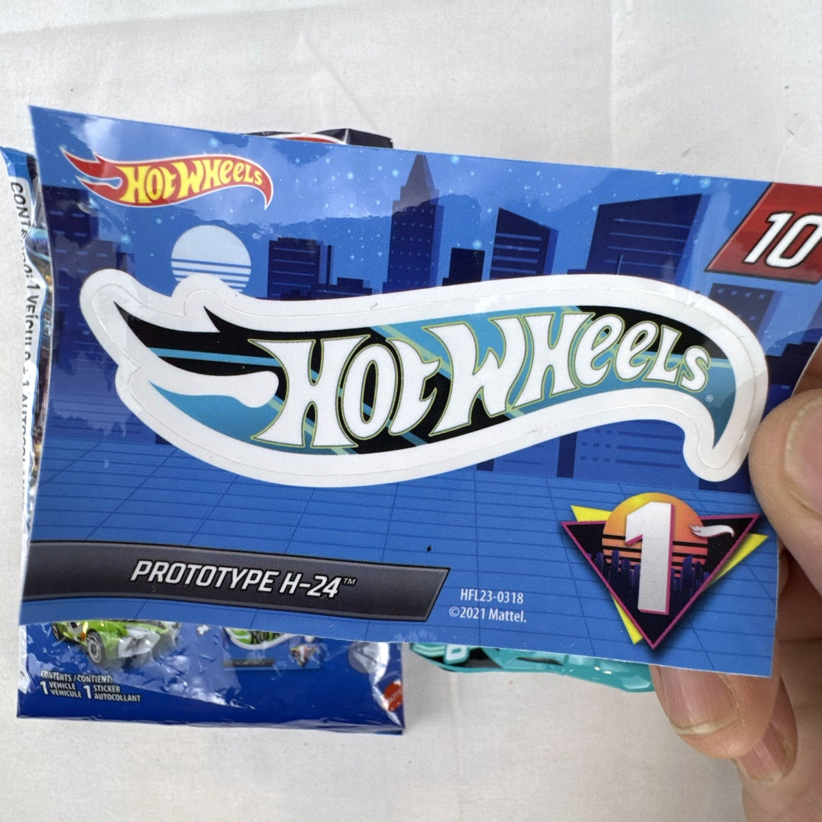 Teal Hot Wheels Prototype H-24 diecast 1:64 scale car with number 10 racing graphics and white 5-spoke wheels.