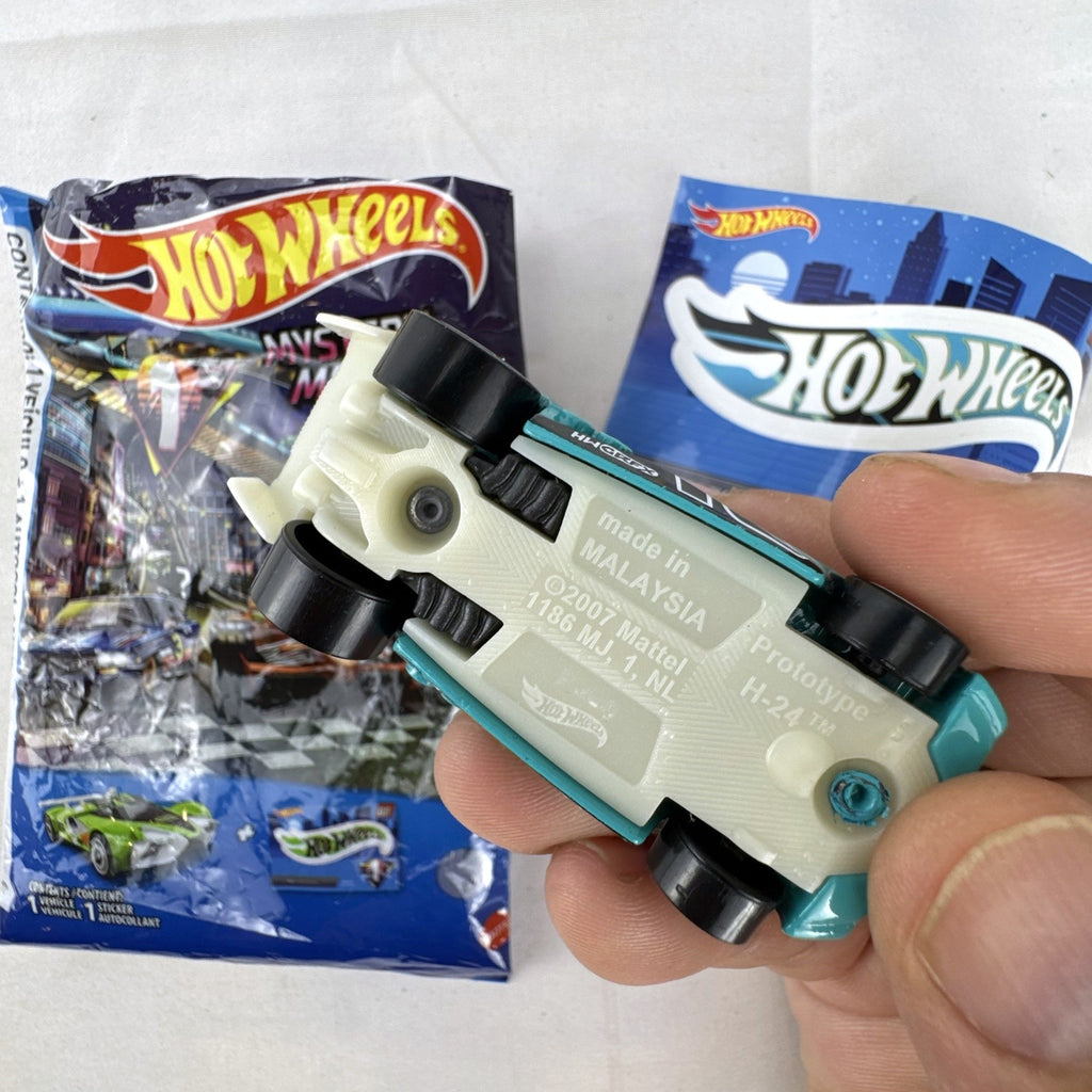 Teal Hot Wheels Prototype H-24 diecast 1:64 scale car with number 10 racing graphics and white 5-spoke wheels.