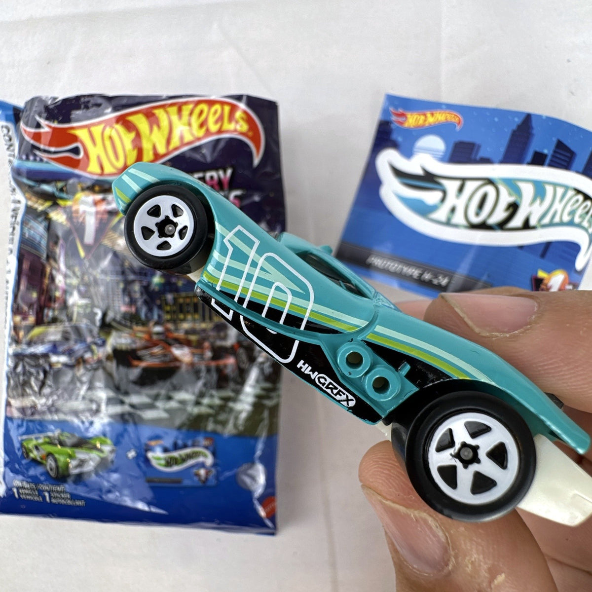 Teal Hot Wheels Prototype H-24 diecast 1:64 scale car with number 10 racing graphics and white 5-spoke wheels.