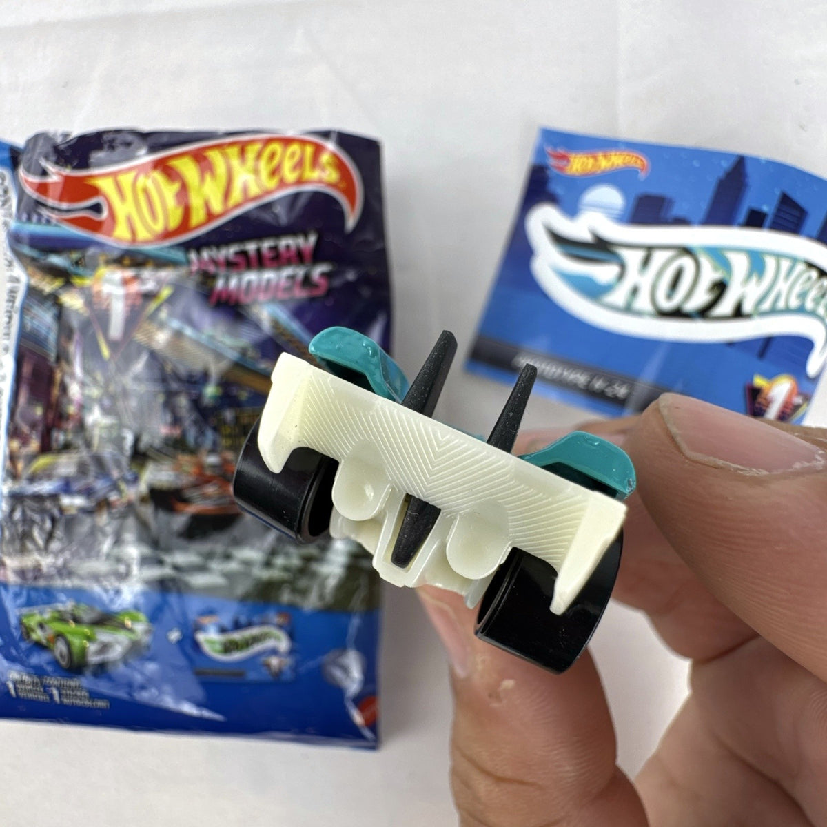 Teal Hot Wheels Prototype H-24 diecast 1:64 scale car with number 10 racing graphics and white 5-spoke wheels.
