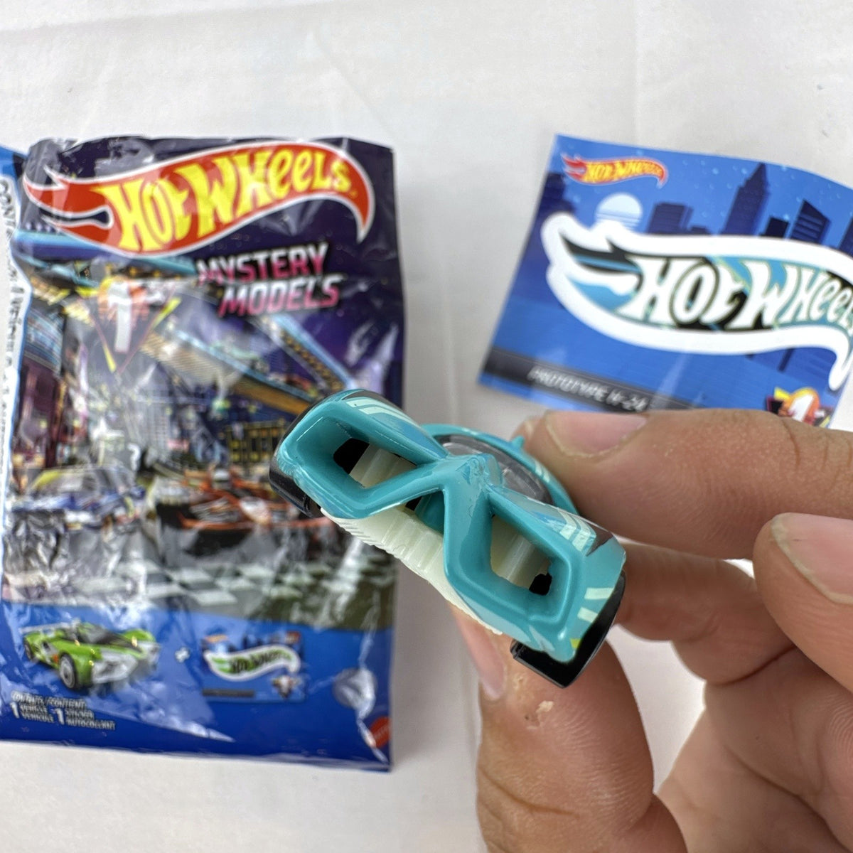 Teal Hot Wheels Prototype H-24 diecast 1:64 scale car with number 10 racing graphics and white 5-spoke wheels.