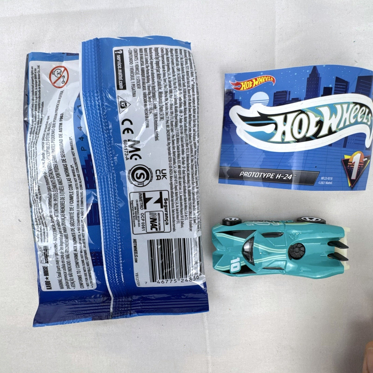 Teal Hot Wheels Prototype H-24 diecast 1:64 scale car with number 10 racing graphics and white 5-spoke wheels.