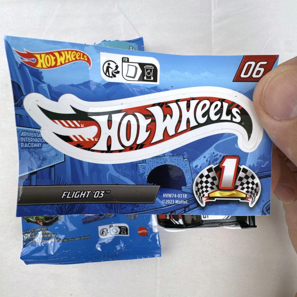 Hot Wheels 1:64 scale Flight '03 diecast car in black with katakana graphics and included sticker from 2024 Mystery Models.