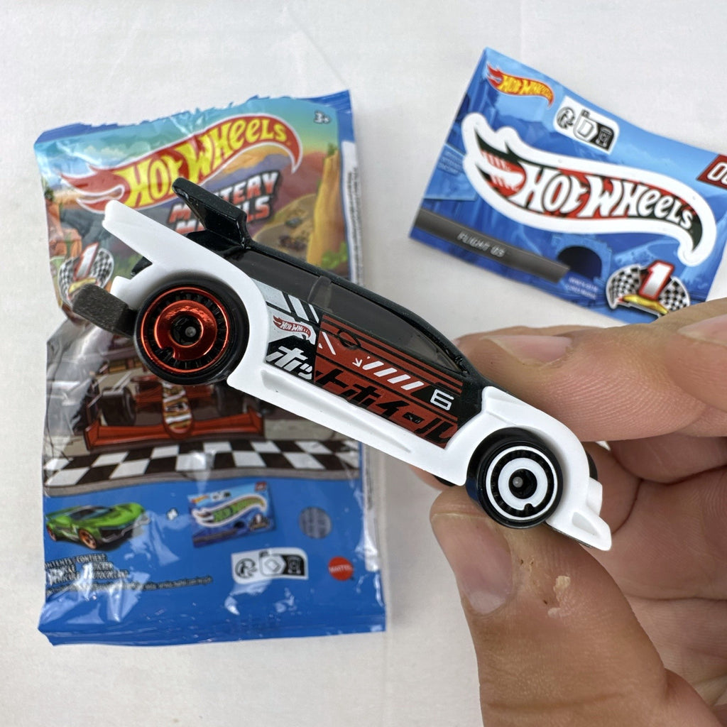 Hot Wheels 1:64 scale Flight '03 diecast car in black with katakana graphics and included sticker from 2024 Mystery Models.