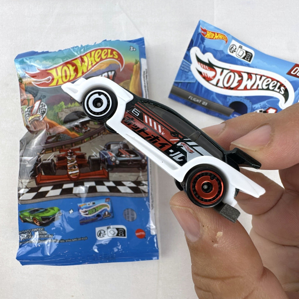 Hot Wheels 1:64 scale Flight '03 diecast car in black with katakana graphics and included sticker from 2024 Mystery Models.