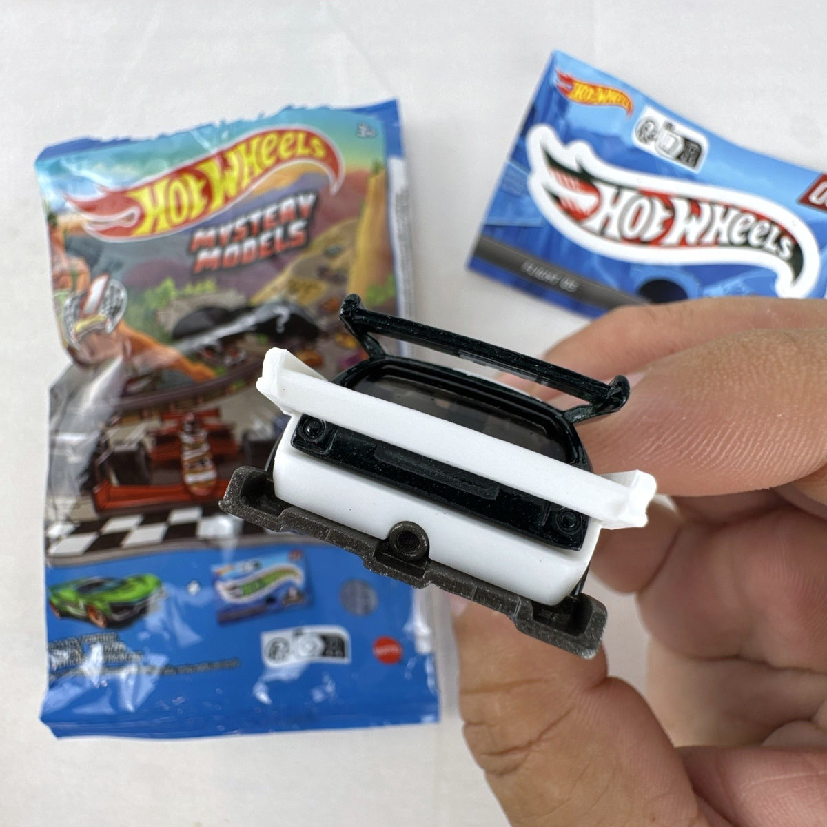 Hot Wheels 1:64 scale Flight '03 diecast car in black with katakana graphics and included sticker from 2024 Mystery Models.