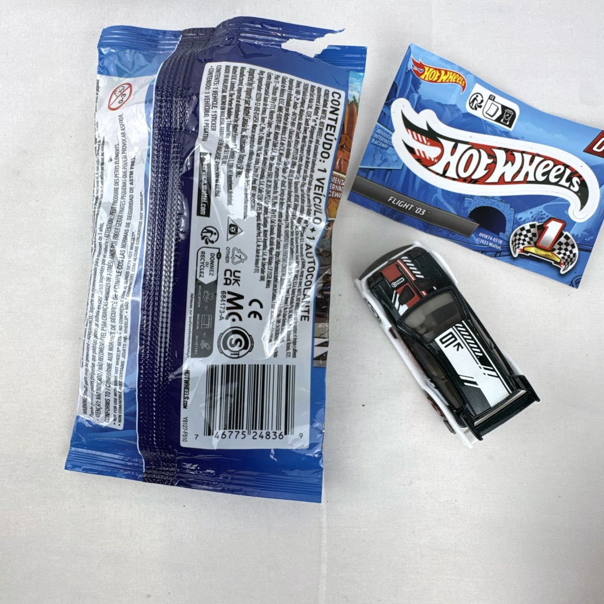 Hot Wheels 1:64 scale Flight '03 diecast car in black with katakana graphics and included sticker from 2024 Mystery Models.