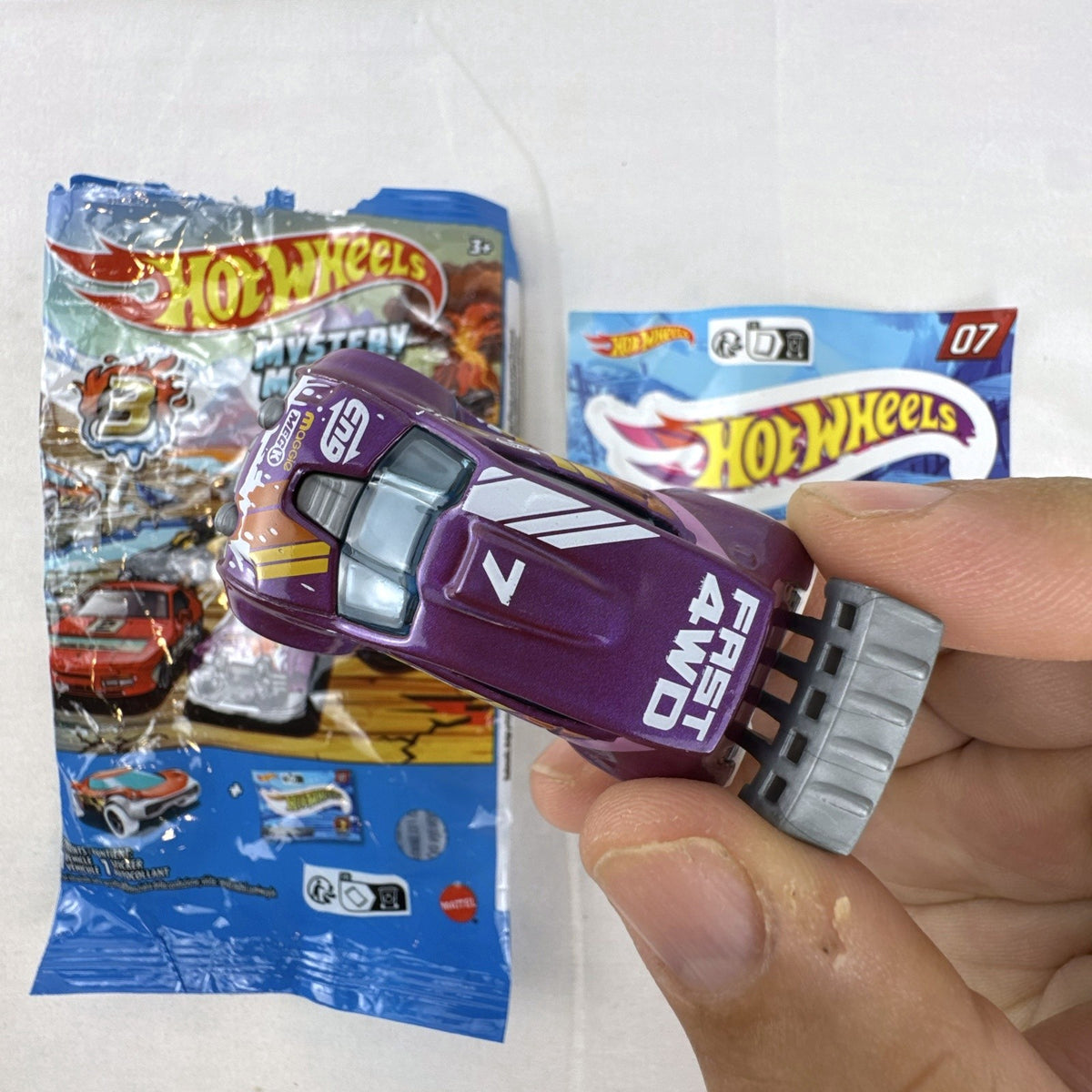 Hot Wheels 1:64 scale Fast 4WD diecast car in metallic purple from Mystery Models Series 3 with original packaging