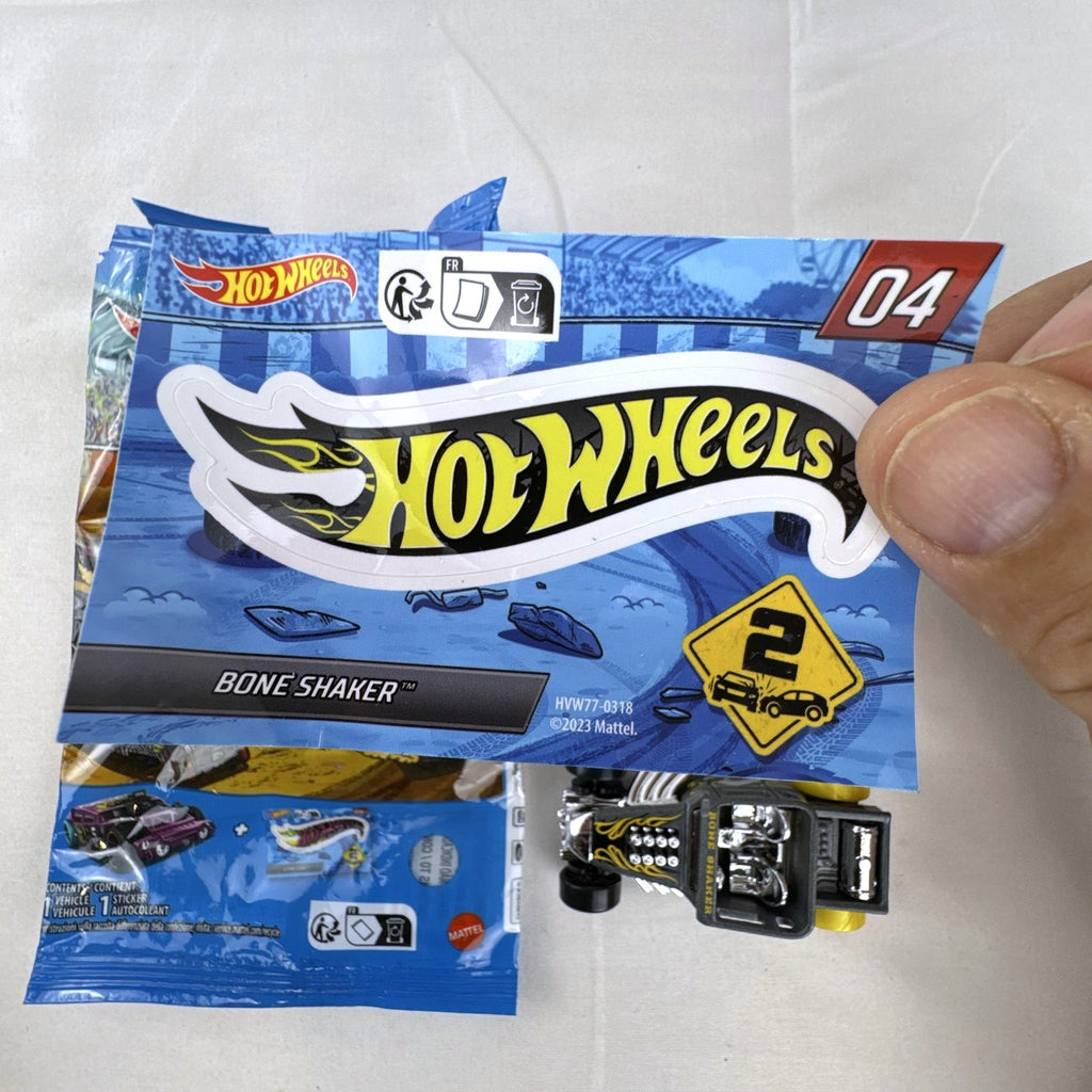 Hot Wheels 1:64 scale satin dark gray Bone Shaker mystery model diecast car with original mystery pouch and sticker