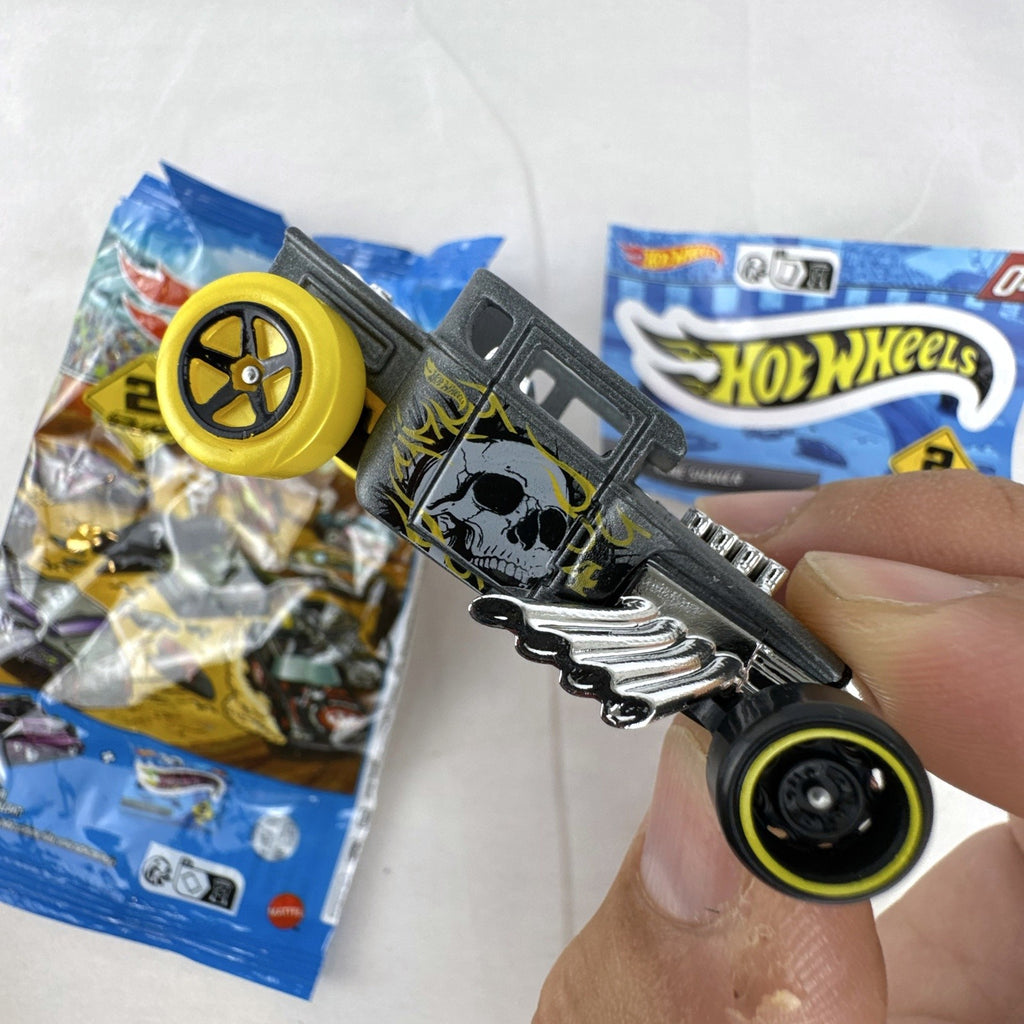 Hot Wheels 1:64 scale satin dark gray Bone Shaker mystery model diecast car with original mystery pouch and sticker