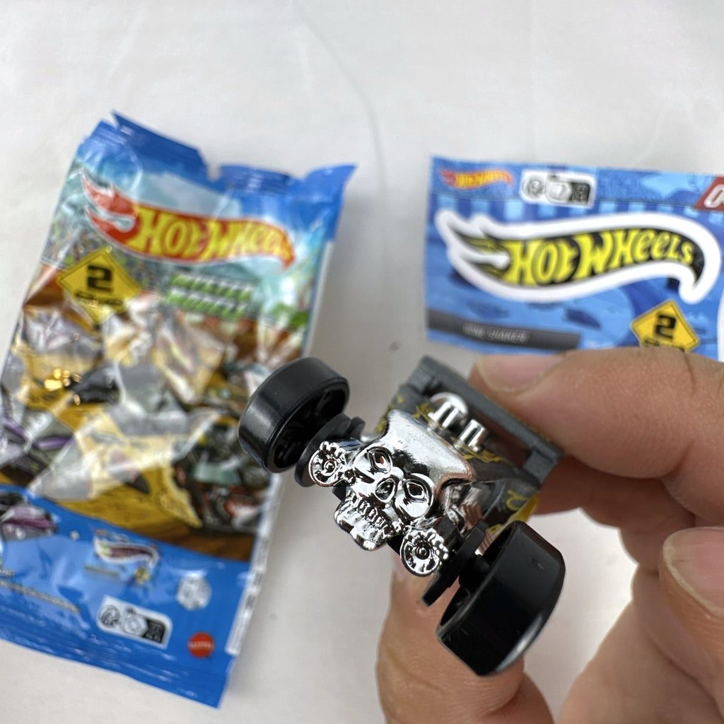 Hot Wheels 1:64 scale satin dark gray Bone Shaker mystery model diecast car with original mystery pouch and sticker