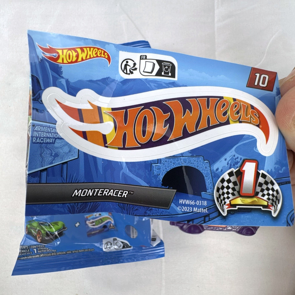 Hot Wheels 1:64 scale Monteracer diecast car in purple and orange from Mystery Models Series 1 with original bag and sticker.