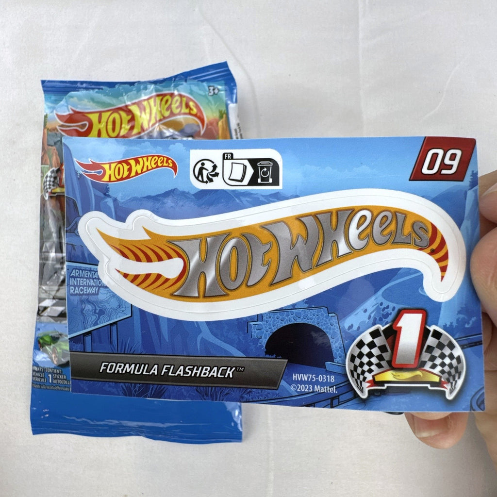 Hot Wheels 1:64 scale Formula Flashback Mystery Models Series 1 yellow diecast racer with sticker card and opened foil pouch