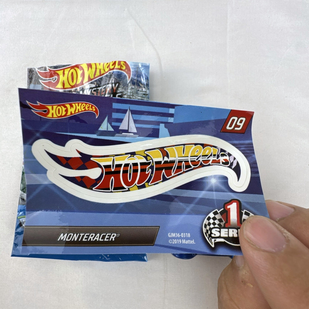 Blue 1:64 scale Hot Wheels Monteracer #09 Mystery Models diecast car with red and yellow graphics.