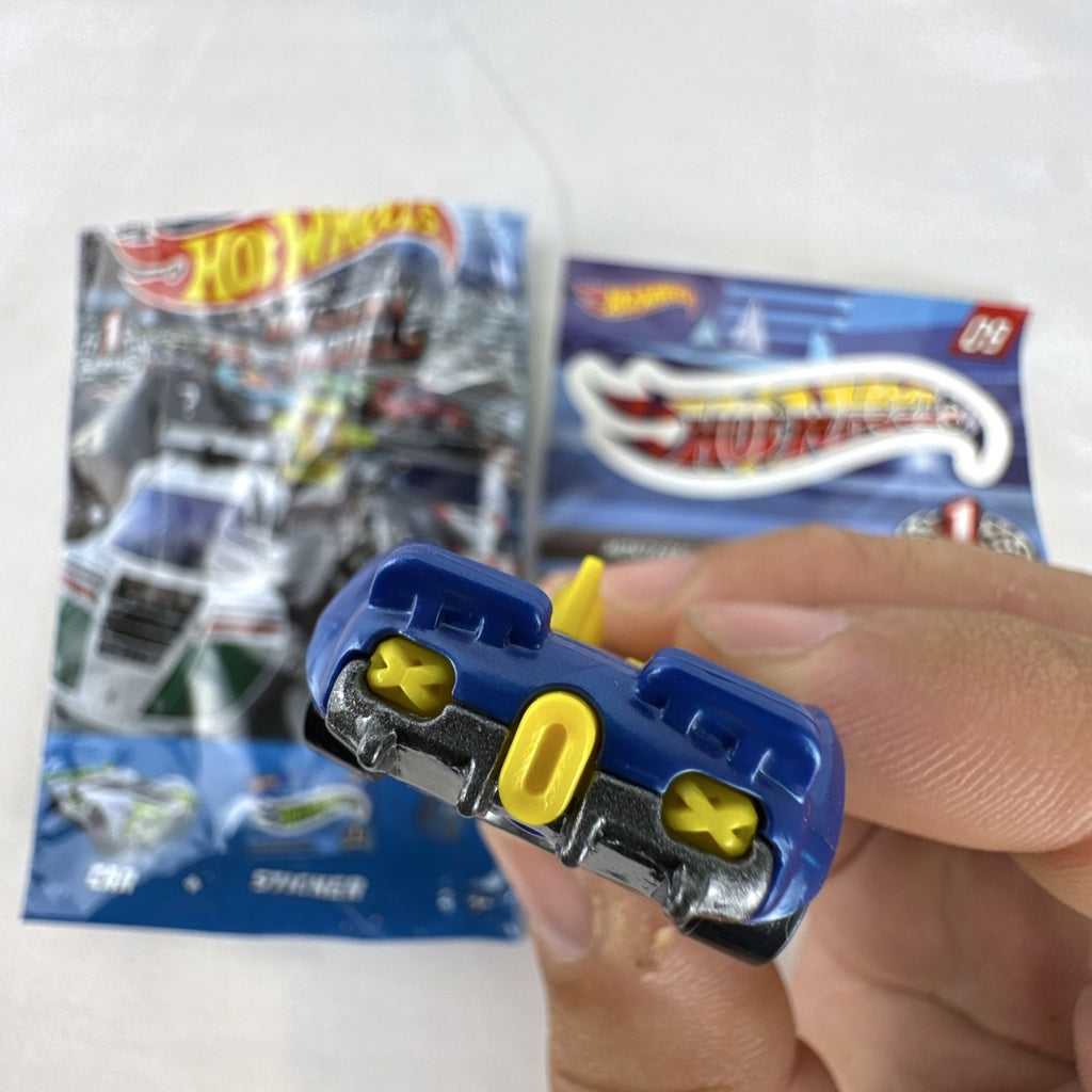 Blue 1:64 scale Hot Wheels Monteracer #09 Mystery Models diecast car with red and yellow graphics.