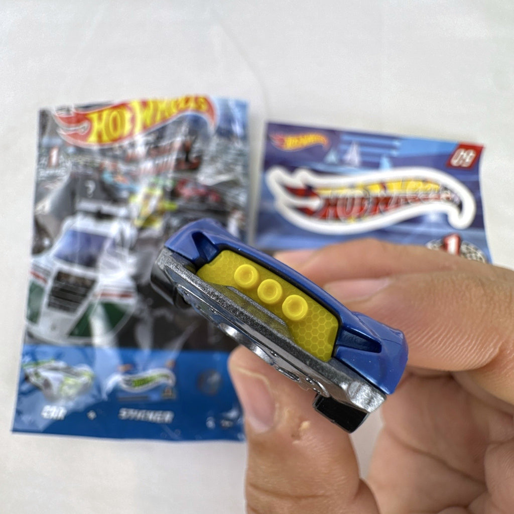 Blue 1:64 scale Hot Wheels Monteracer #09 Mystery Models diecast car with red and yellow graphics.