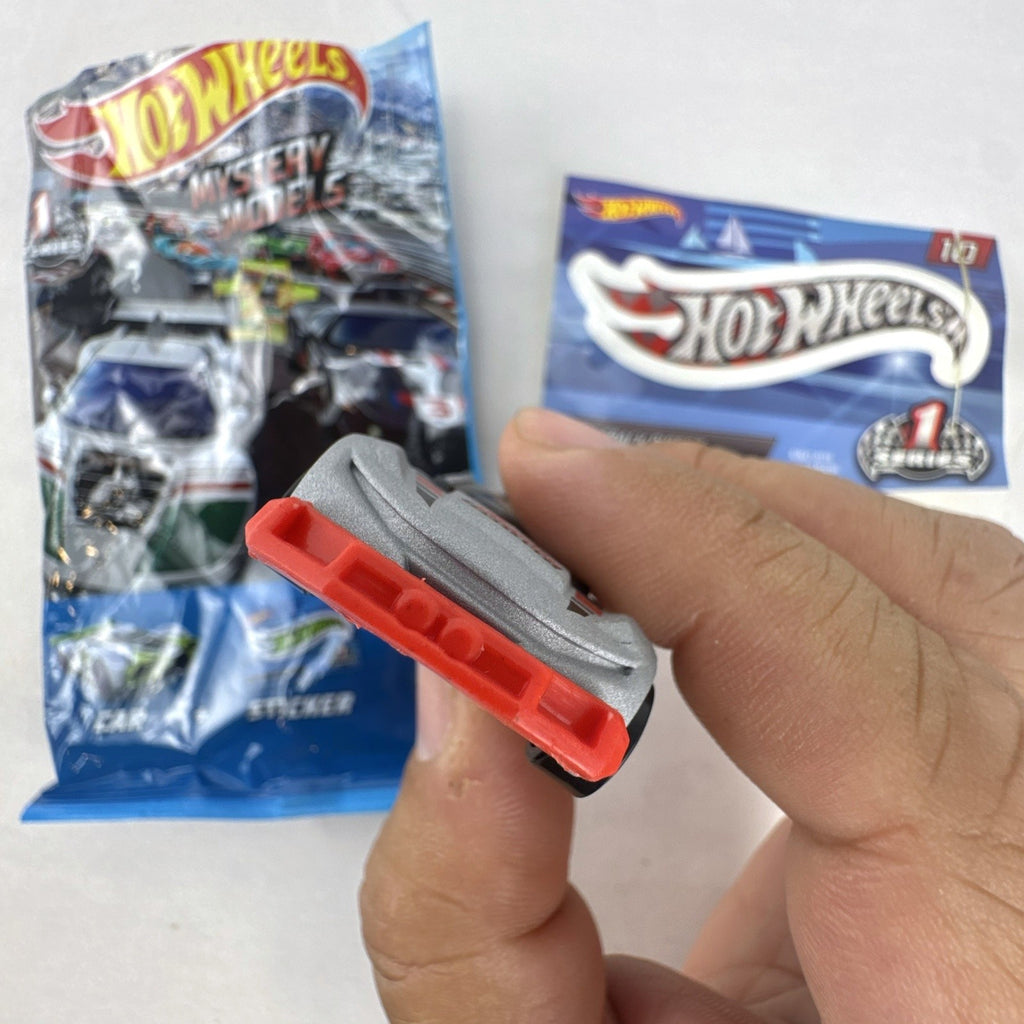 Hot Wheels Track Ripper 1:64 scale diecast car in silver with red racing graphics and matching #10 sticker.