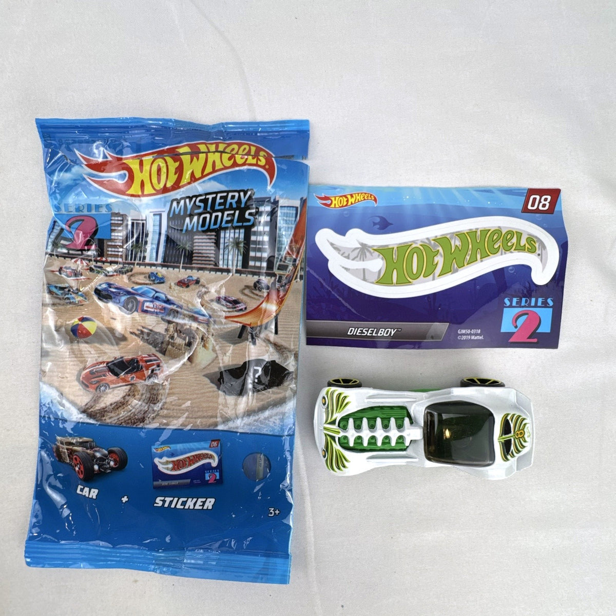 Hot Wheels 1:64 scale Dieselboy diecast car in white and green with original 2020 Mystery Models Series 2 bag and sticker card.