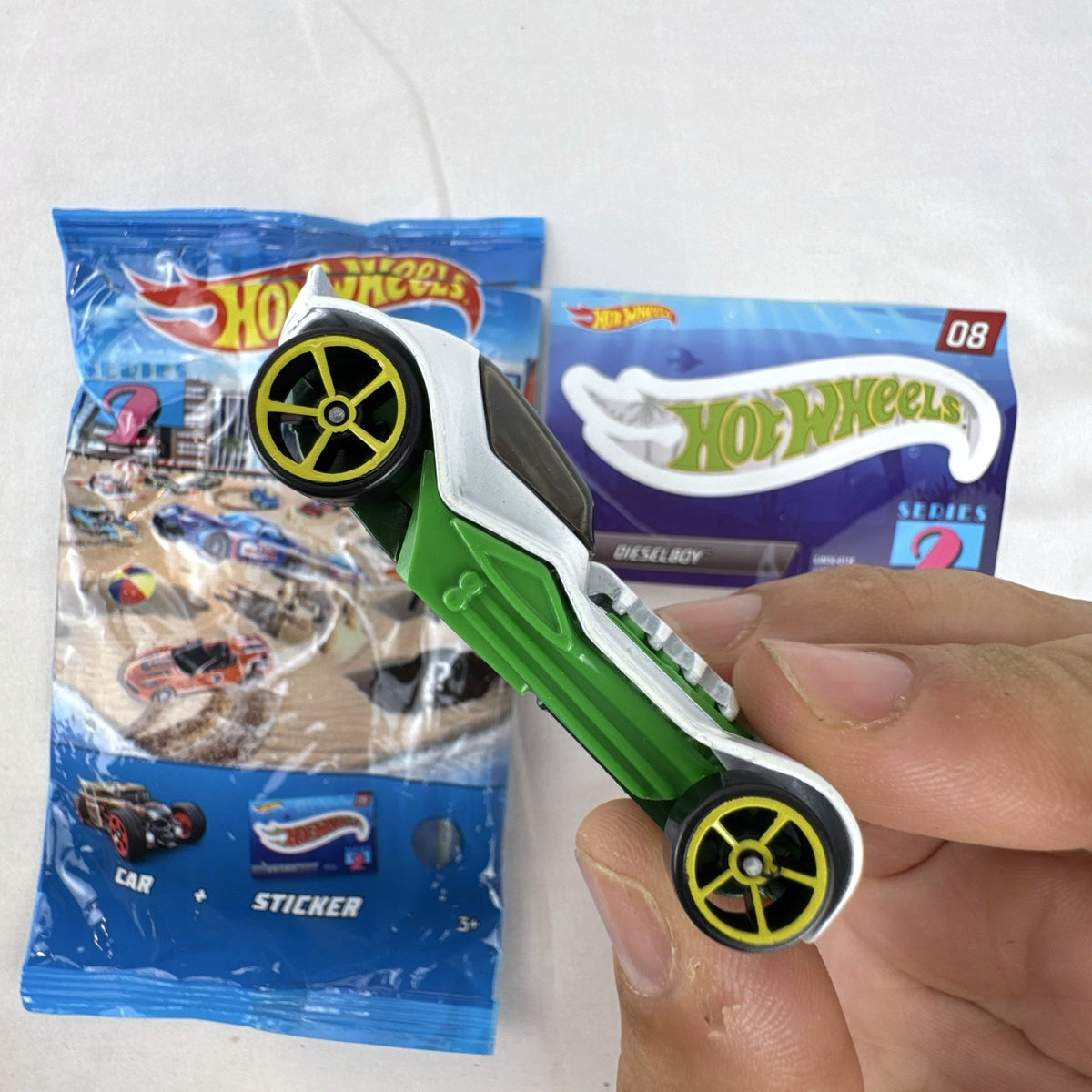 Hot Wheels 1:64 scale Dieselboy diecast car in white and green with original 2020 Mystery Models Series 2 bag and sticker card.