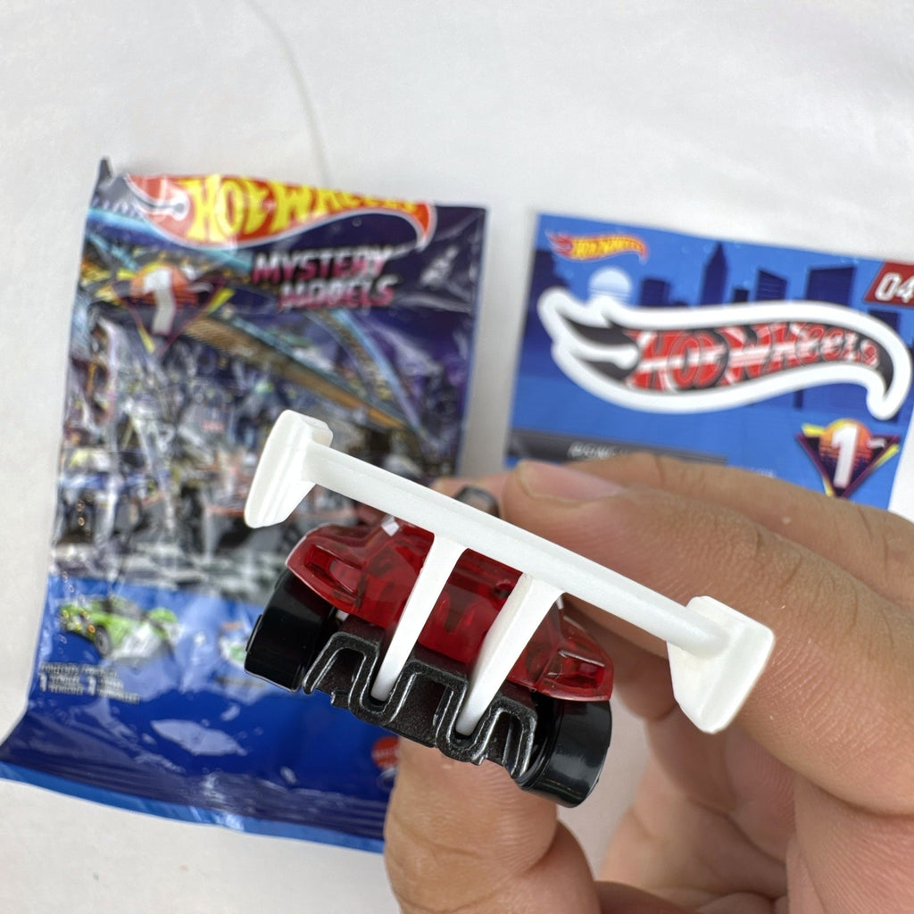 Hot Wheels 1:64 scale Rising Heat mystery model diecast car in translucent red with white number 4 racing graphics.