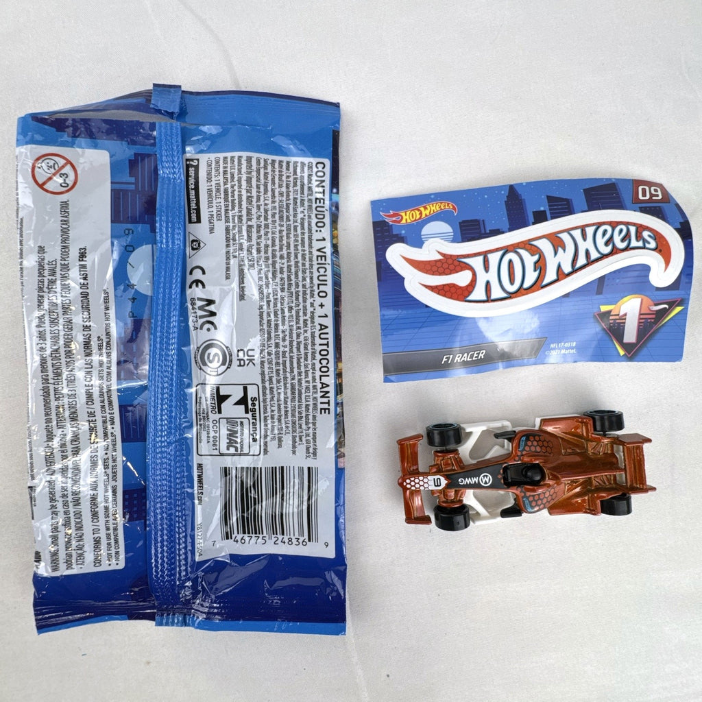 Hot Wheels 1:64 scale F1 Racer diecast car in metallic copper orange with original Mystery Models foil pouch and sticker