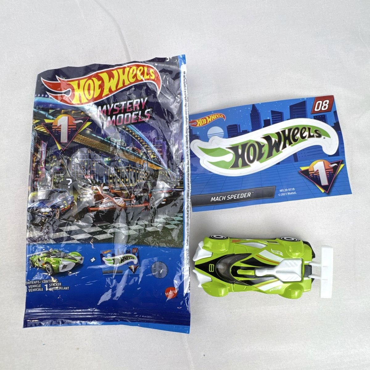 Hot Wheels 2021 Mystery Models Series 1 Mach Speeder #08 diecast car in bright lime green with matching sticker card.