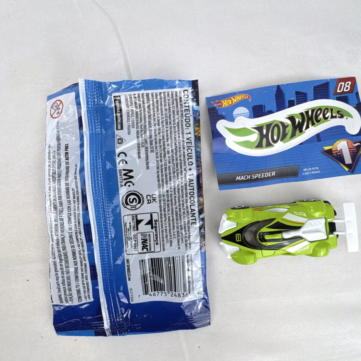 Hot Wheels 2021 Mystery Models Series 1 Mach Speeder #08 diecast car in bright lime green with matching sticker card.