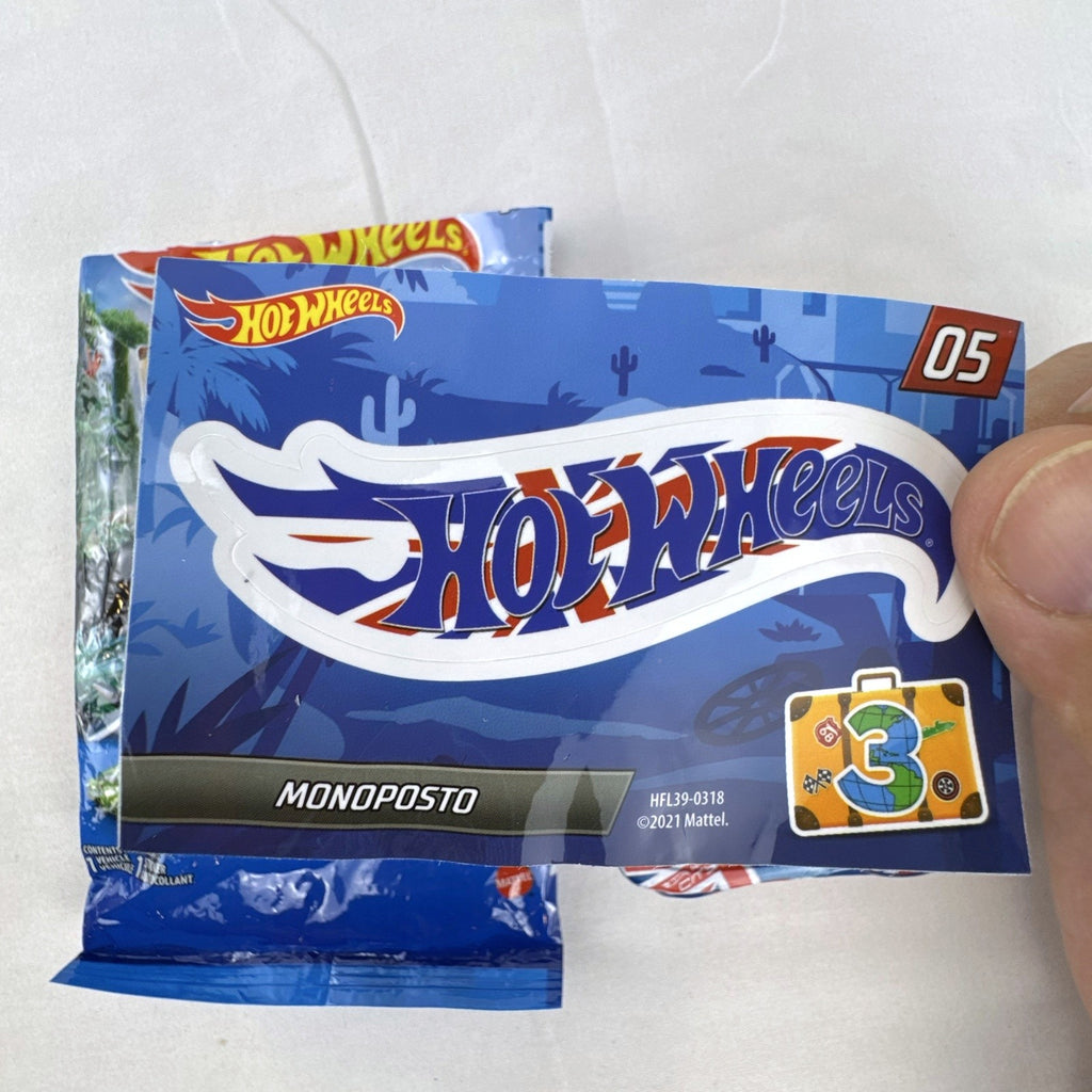 Hot Wheels Monoposto Mystery Models Series 3 #05 blue diecast car with Union Jack livery, original bag, and sticker card.