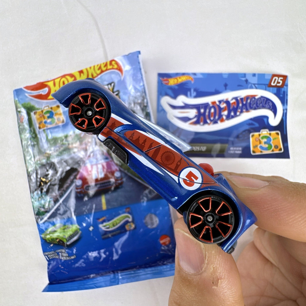 Hot Wheels Monoposto Mystery Models Series 3 #05 blue diecast car with Union Jack livery, original bag, and sticker card.