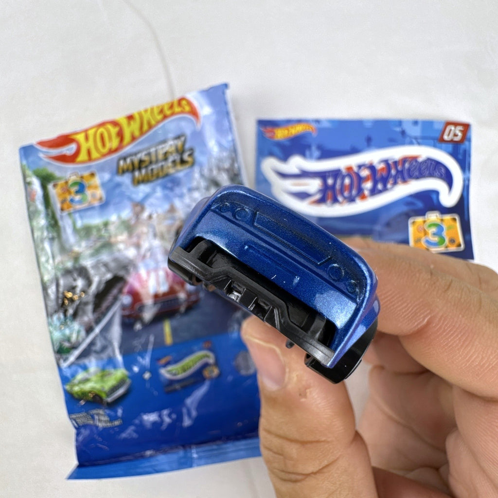 Hot Wheels Monoposto Mystery Models Series 3 #05 blue diecast car with Union Jack livery, original bag, and sticker card.