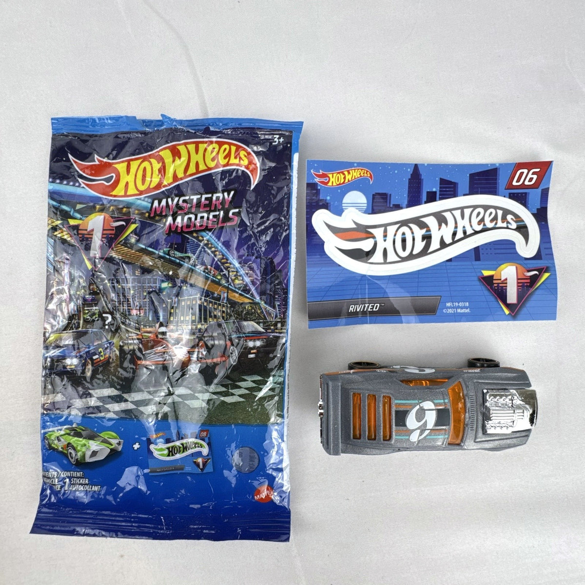 Hot Wheels 1:64 scale Rivited mystery models series 1 dark gray diecast car with exposed chrome engine and #9 graphics