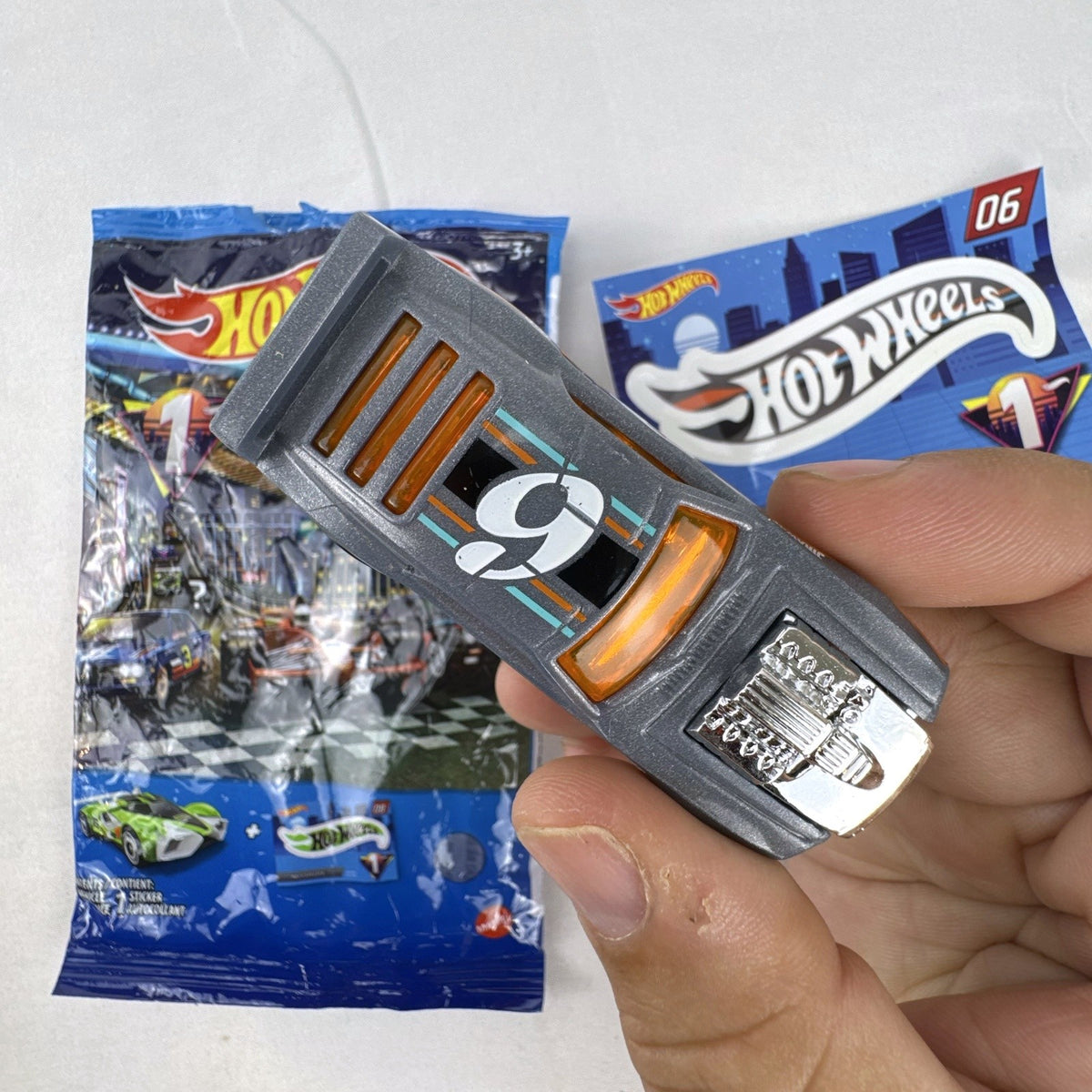 Hot Wheels 1:64 scale Rivited mystery models series 1 dark gray diecast car with exposed chrome engine and #9 graphics
