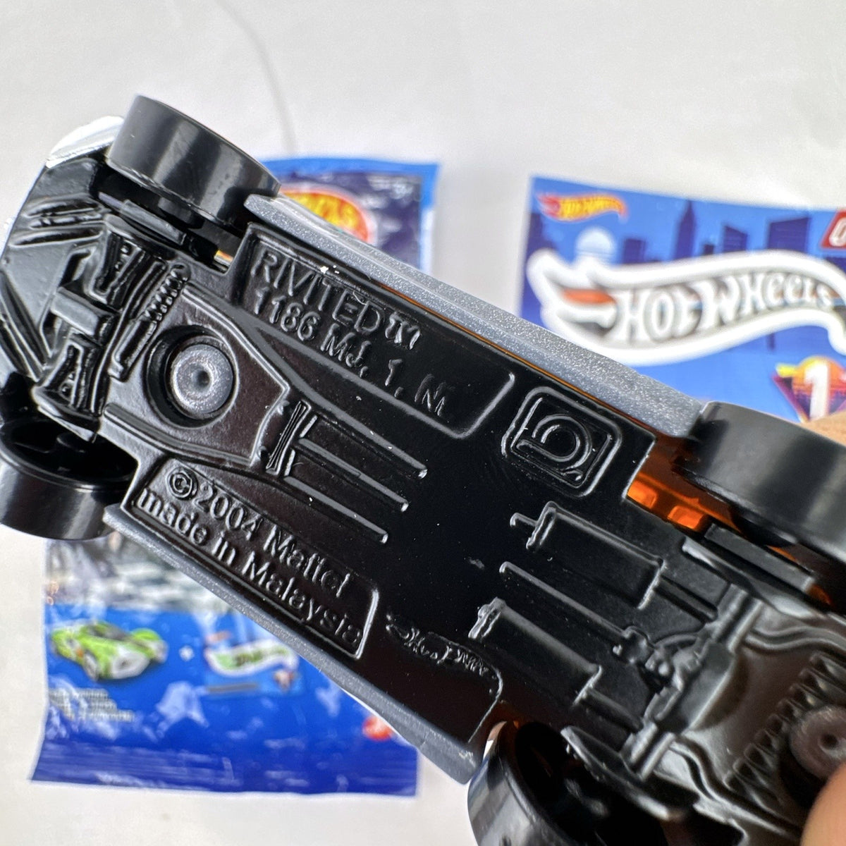 Hot Wheels 1:64 scale Rivited mystery models series 1 dark gray diecast car with exposed chrome engine and #9 graphics