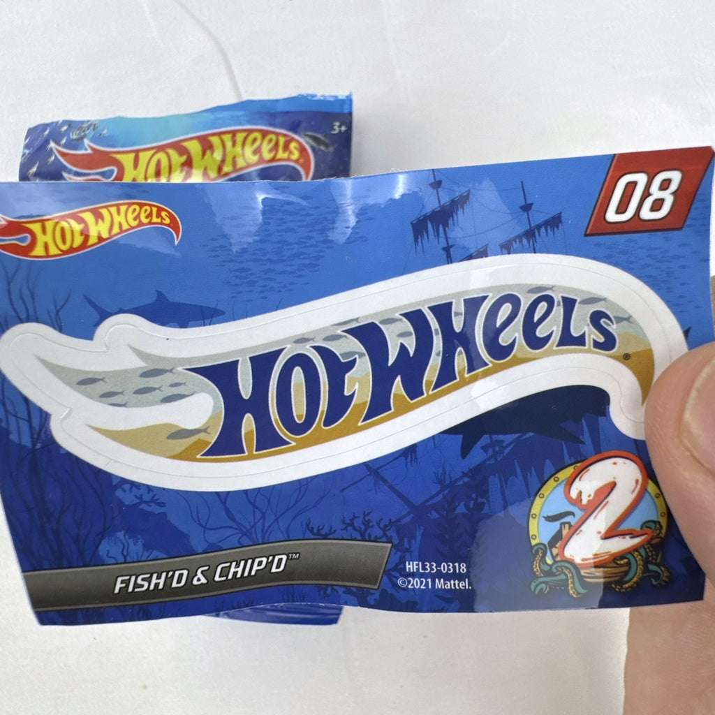 Hot Wheels Fish'd & Chip'd 1:64 scale diecast car in light blue with Union Jack roof graphic and bonus sticker.