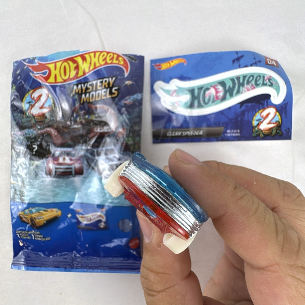 Hot Wheels Clear Speeder translucent blue diecast car Series 2 Mystery Model 04 with sticker sheet and packaging