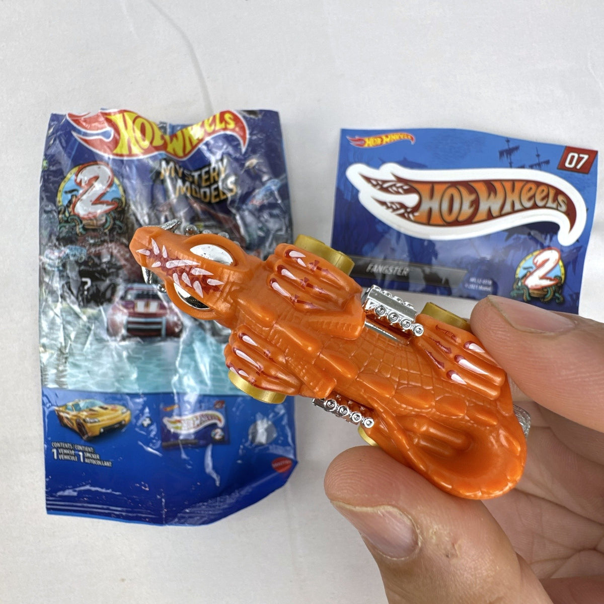 Hot Wheels Mystery Models Series 2 Fangster orange 1:64 scale diecast car with original bag and sticker