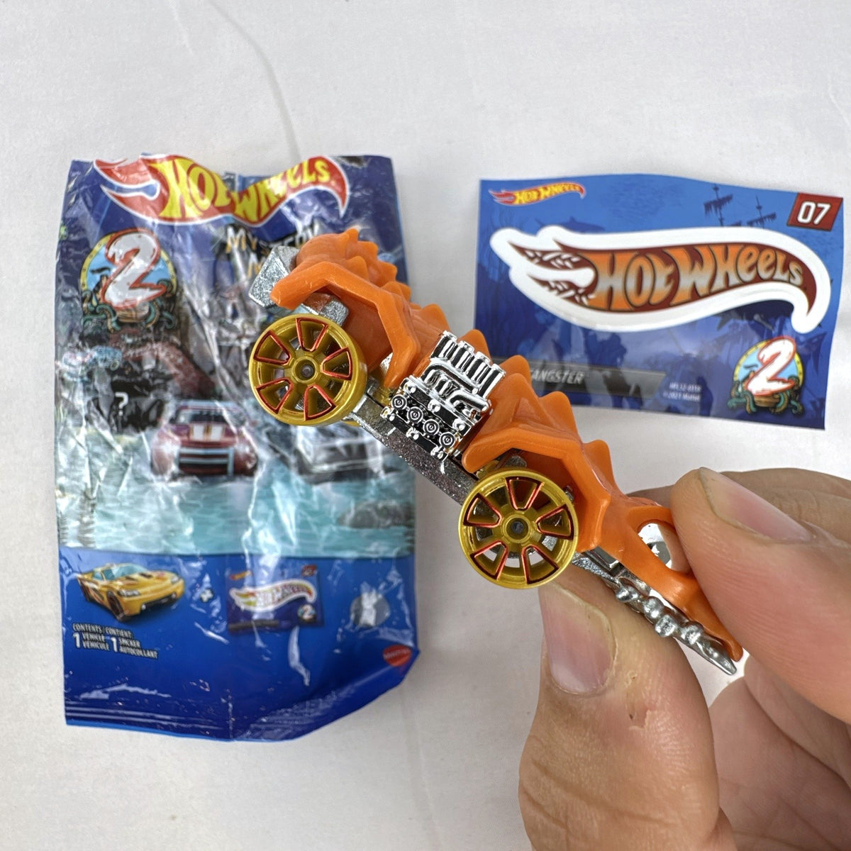 Hot Wheels Mystery Models Series 2 Fangster orange 1:64 scale diecast car with original bag and sticker