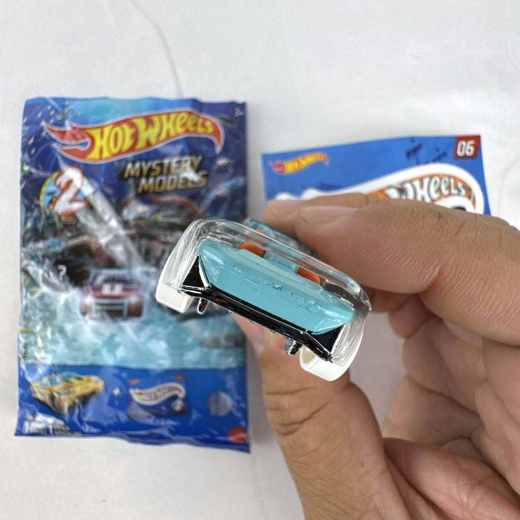 Hot Wheels El Viento Mystery Models Series 2 light blue diecast car with octopus graphics, foil pouch, and sticker card.