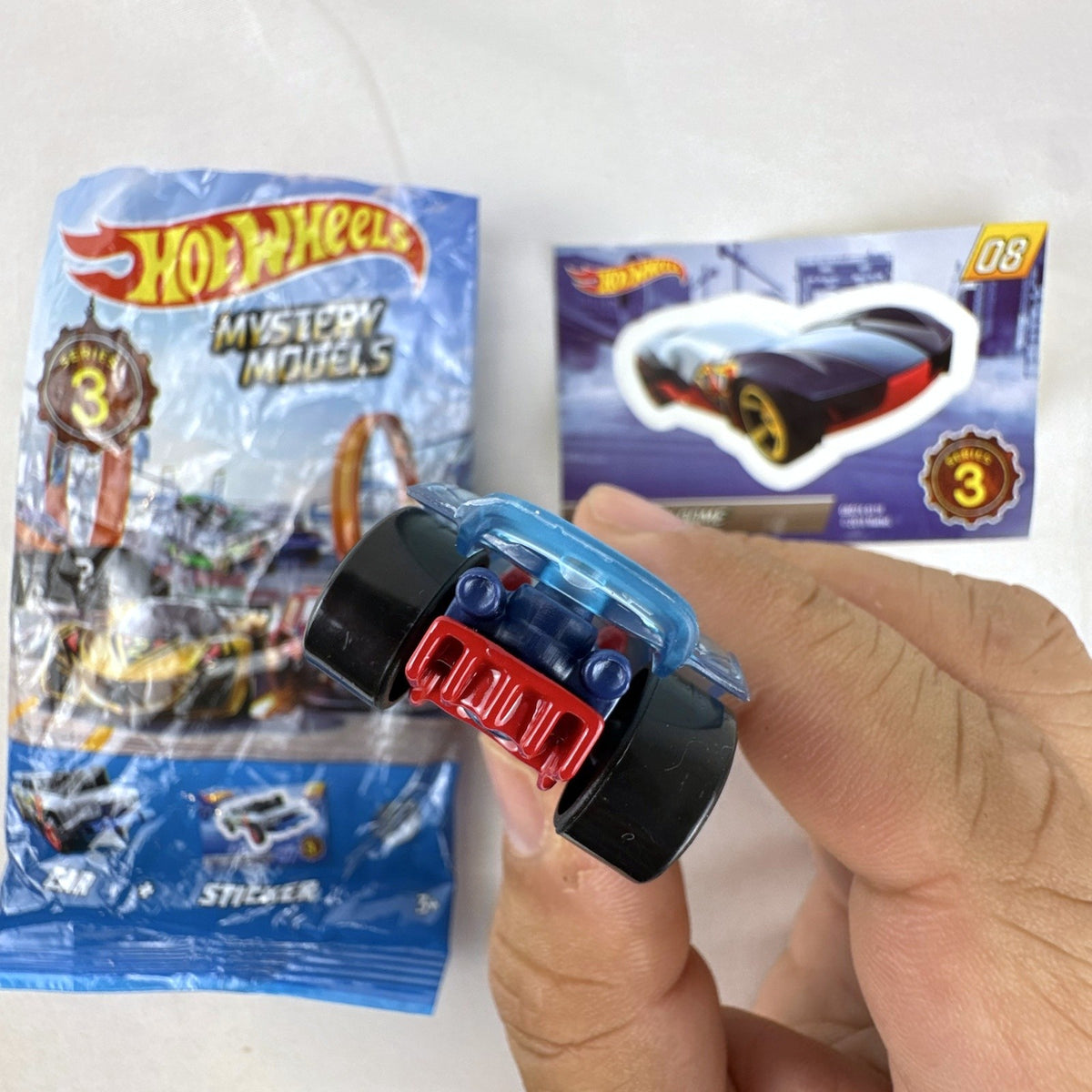 Hot Wheels Sky Dome 1:64 scale diecast car in dark blue with original Mystery Models Series 3 sticker card and bag.