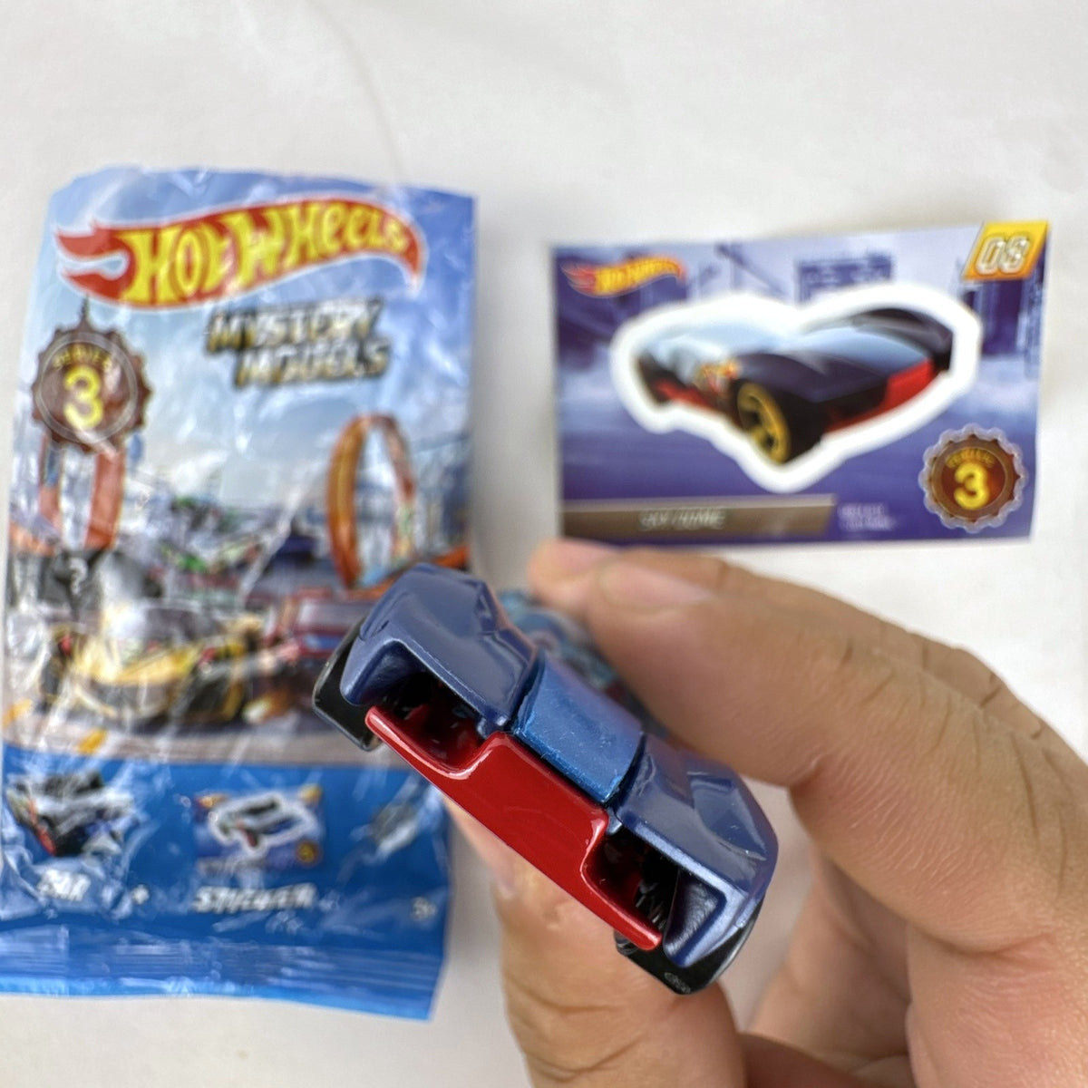 Hot Wheels Sky Dome 1:64 scale diecast car in dark blue with original Mystery Models Series 3 sticker card and bag.