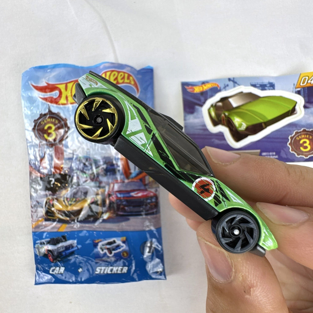 Metallic green Hot Wheels La Fasta 1:64 diecast car from Mystery Models Series 3 with original sticker card.