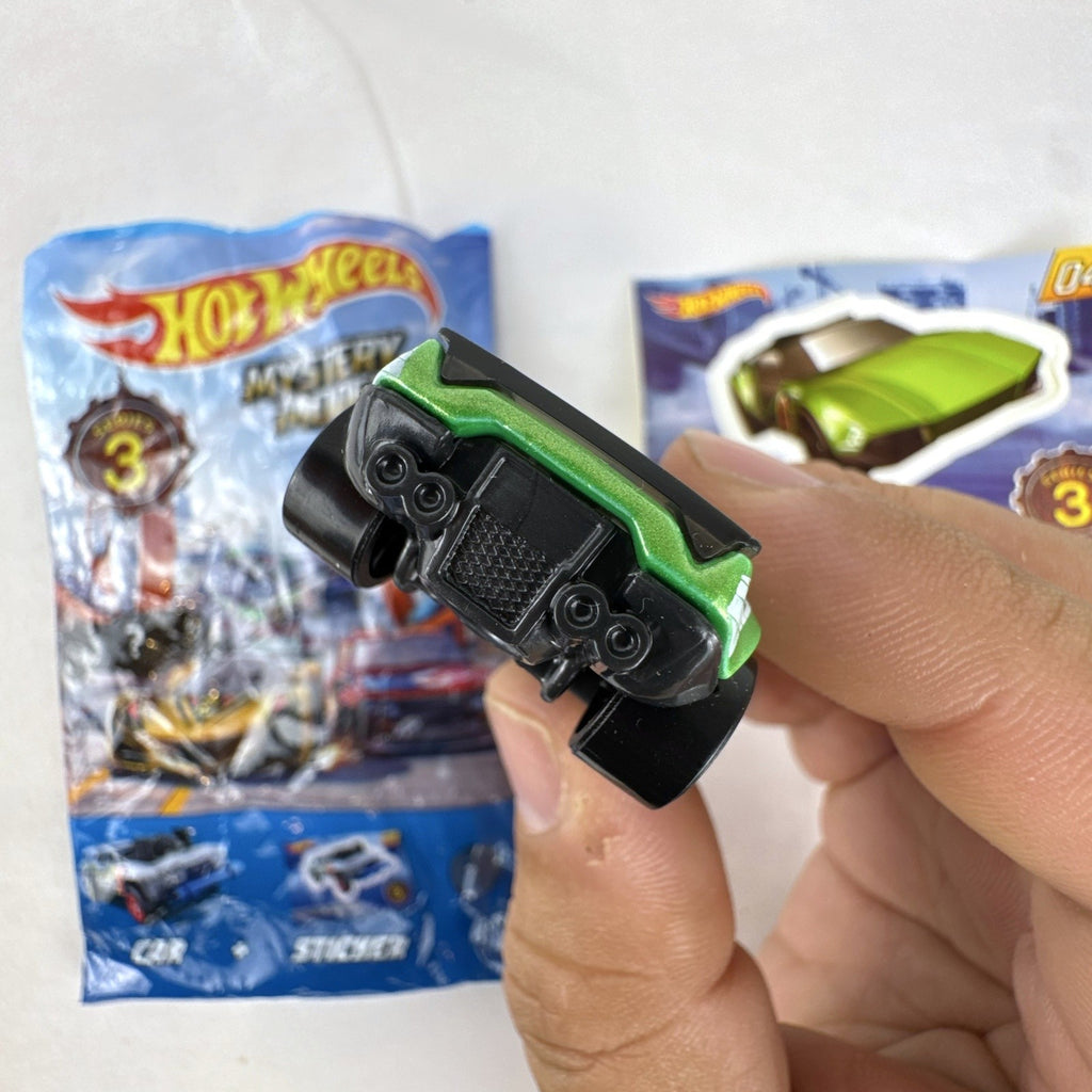 Metallic green Hot Wheels La Fasta 1:64 diecast car from Mystery Models Series 3 with original sticker card.