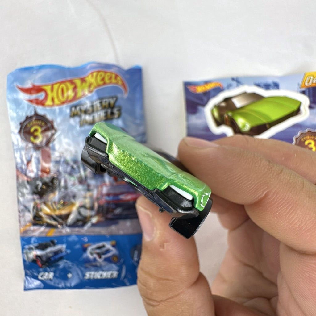 Metallic green Hot Wheels La Fasta 1:64 diecast car from Mystery Models Series 3 with original sticker card.