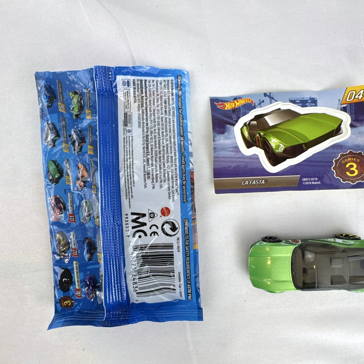 Metallic green Hot Wheels La Fasta 1:64 diecast car from Mystery Models Series 3 with original sticker card.