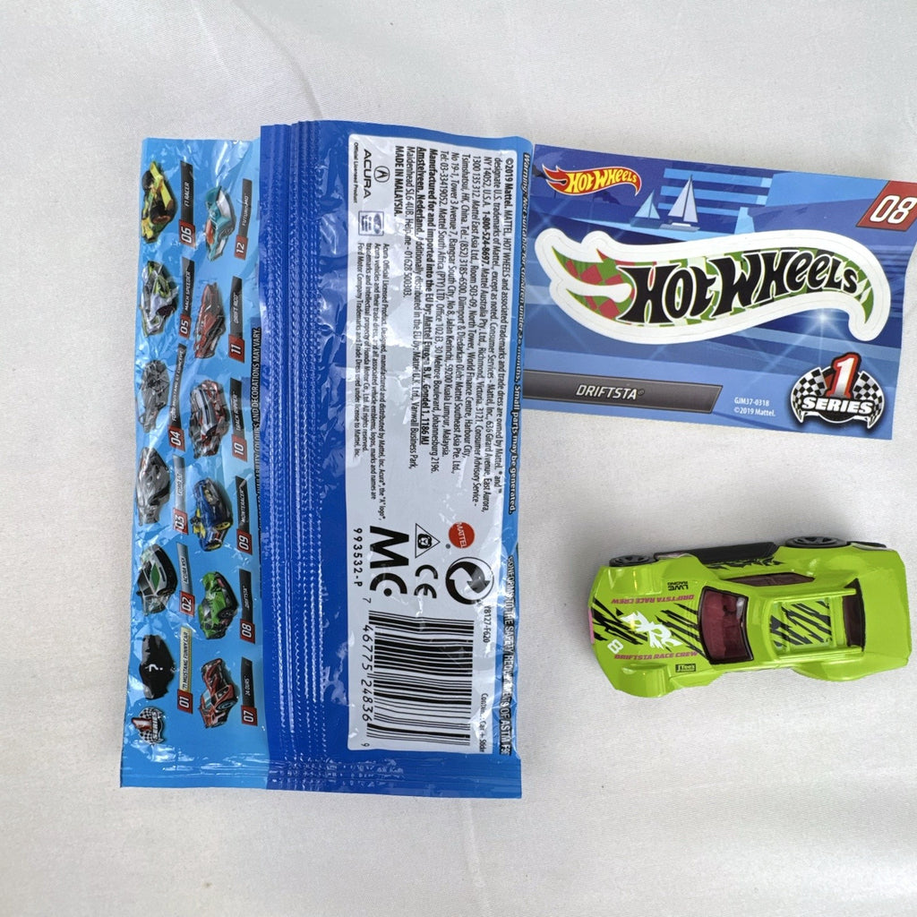 1:64 scale lime green Hot Wheels Driftsta #08 diecast car with Mystery Models sticker card and foil pack.